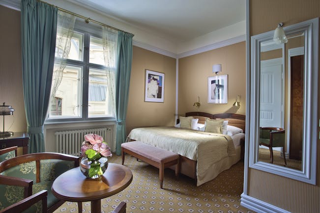 Hotel Paris Prague deluxe bedroom white mirror round table flowers and large window