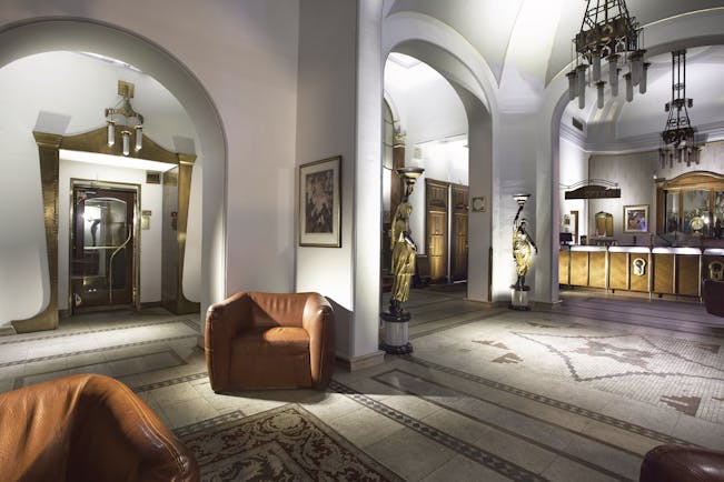 Hotel Paris Prague lobby area  archways mosaic floors chairs and two statue lamps