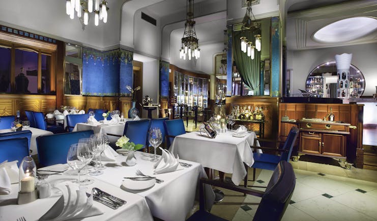 Hotel Paris Prague restaurant Sarah Bernhardt  indoor dining area with wooden panelled walls and chandeliers