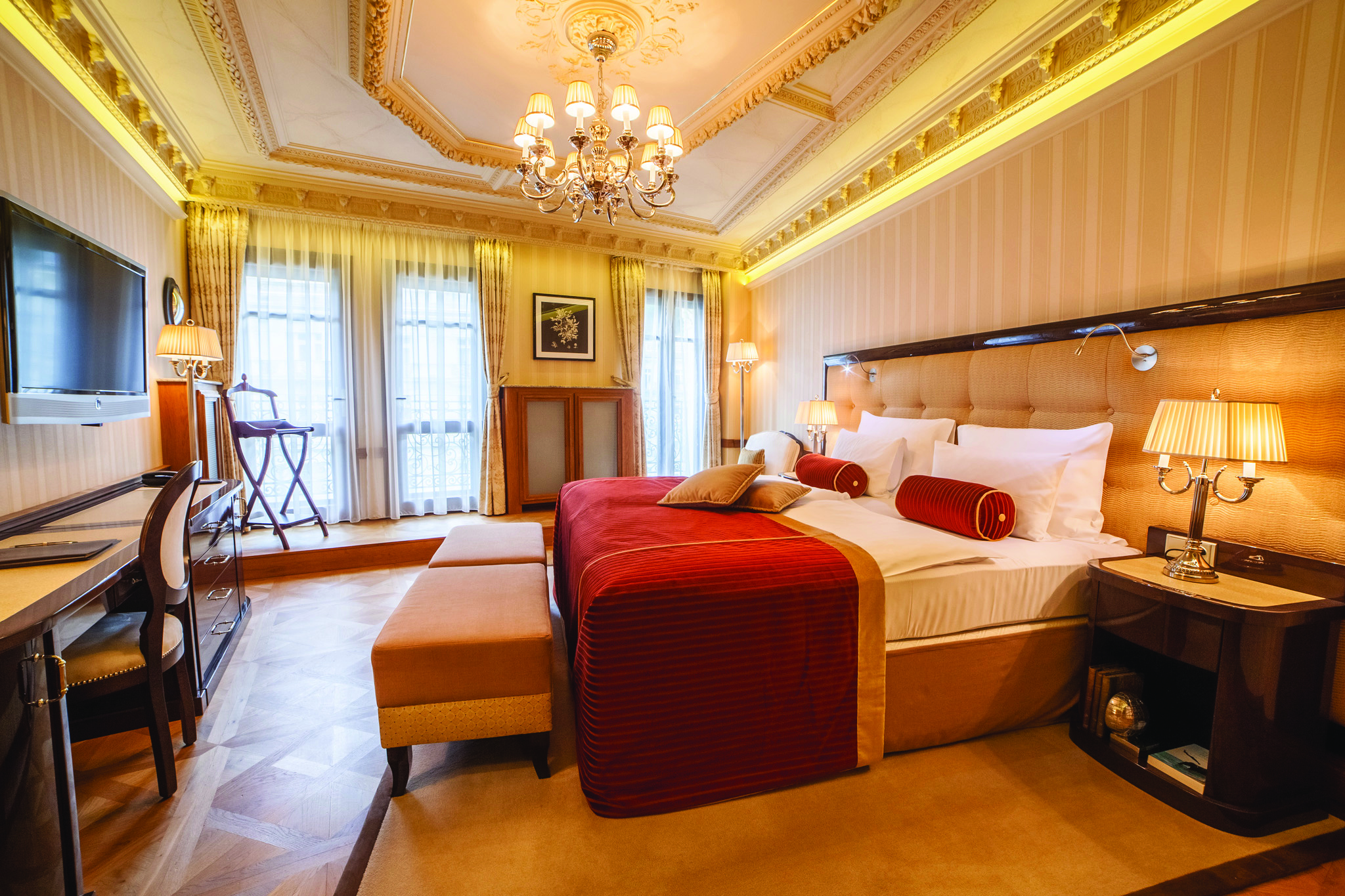 Hotel Quisisana Palace Karlovy Vary deluxe suite bedroom chandelier desk and television