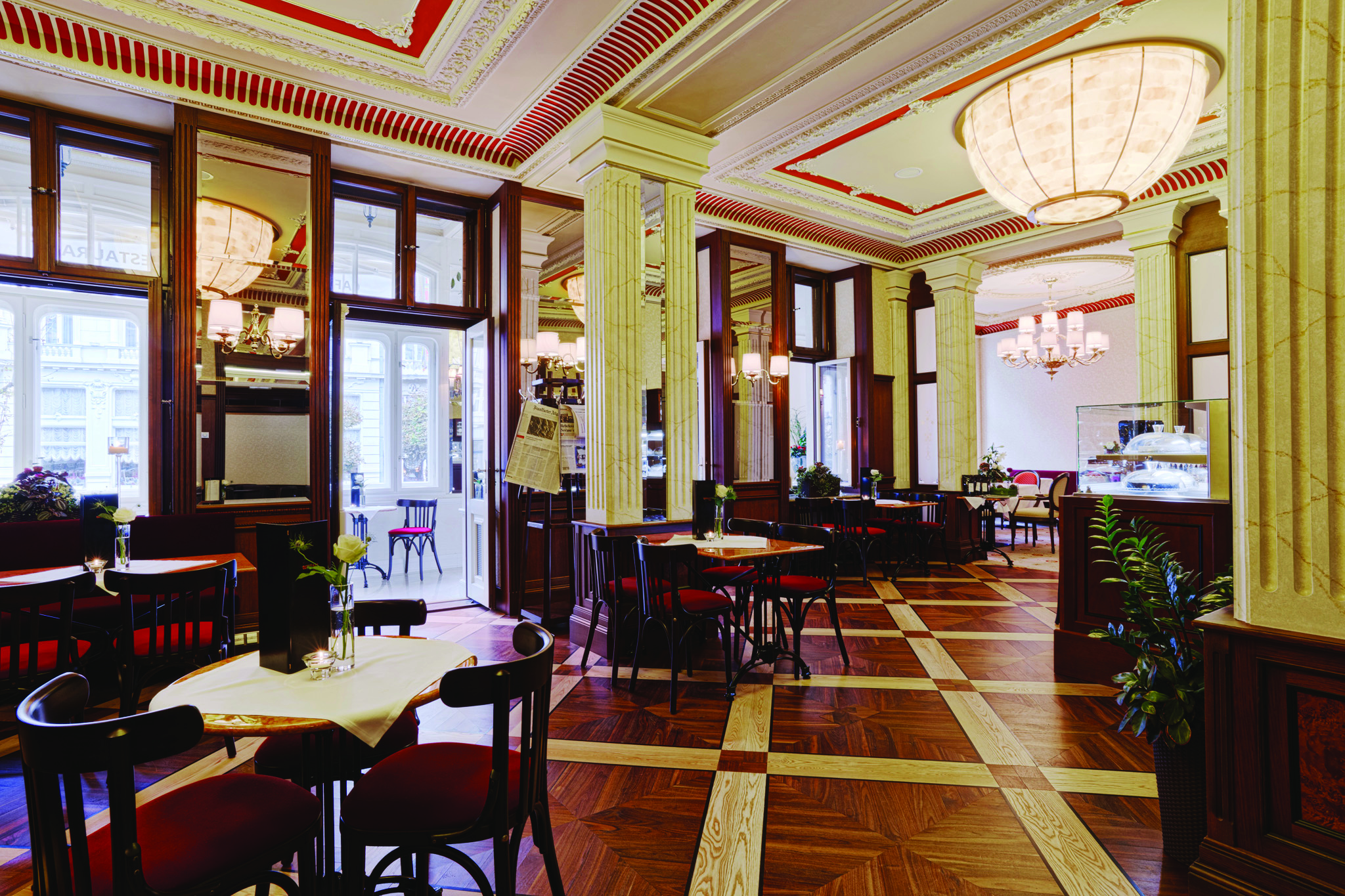 Hotel Quisisana Palace Karlovy Vary restaurant dining room wood panelling wooden floors large windows and ornate ceiling