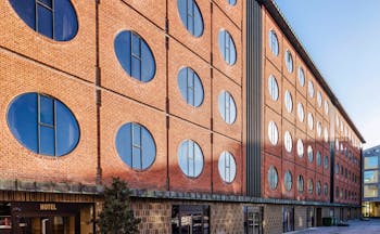 Hotel Ottilia exterior, brick building with round windows, industrial in style