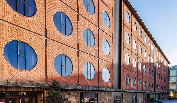 Hotel Ottilia exterior, brick building with round windows, industrial in style