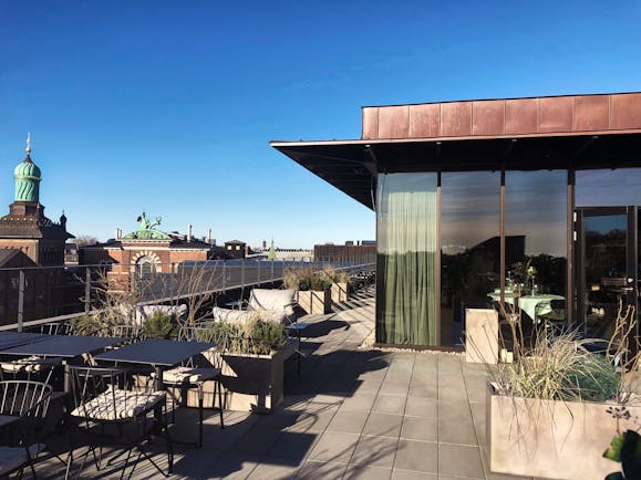 Hotel Ottilia terrace, outside seating area, tables and chairs, blue sky