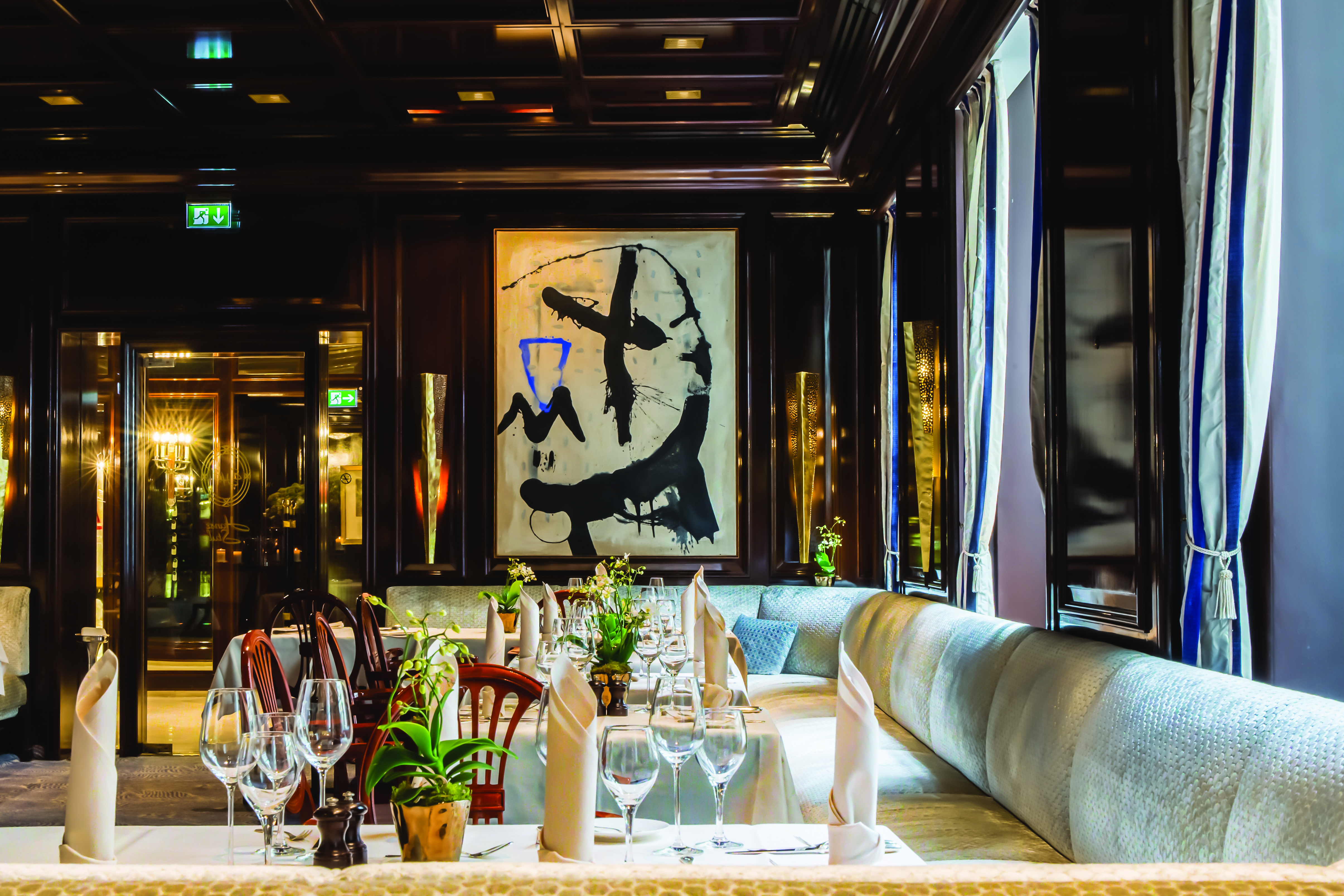 Excelsior Hotel Ernest Cologne restaurant with dark walls and a dark painting