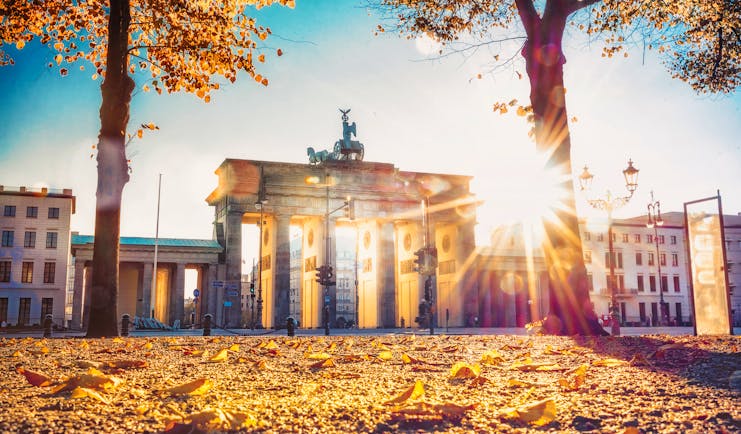 Autumn sunlight shining through the Brandenburg arched gate in Berlin