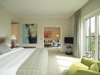 Classic suite at the Charles Hotel with large double bed and bi-folding doors opening onto a balcony