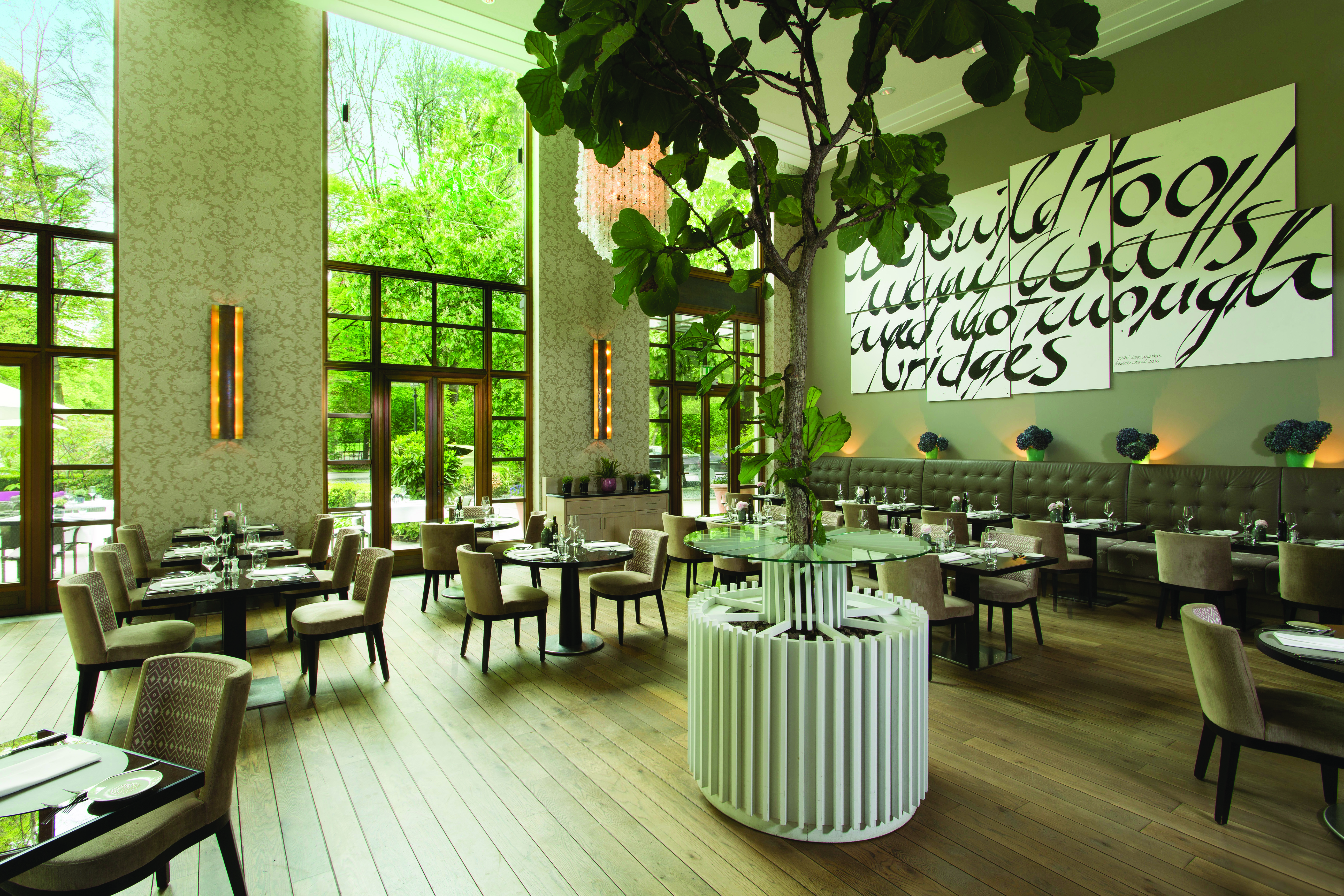 Dining area at the restaurant with high pannelled windows against the walls 