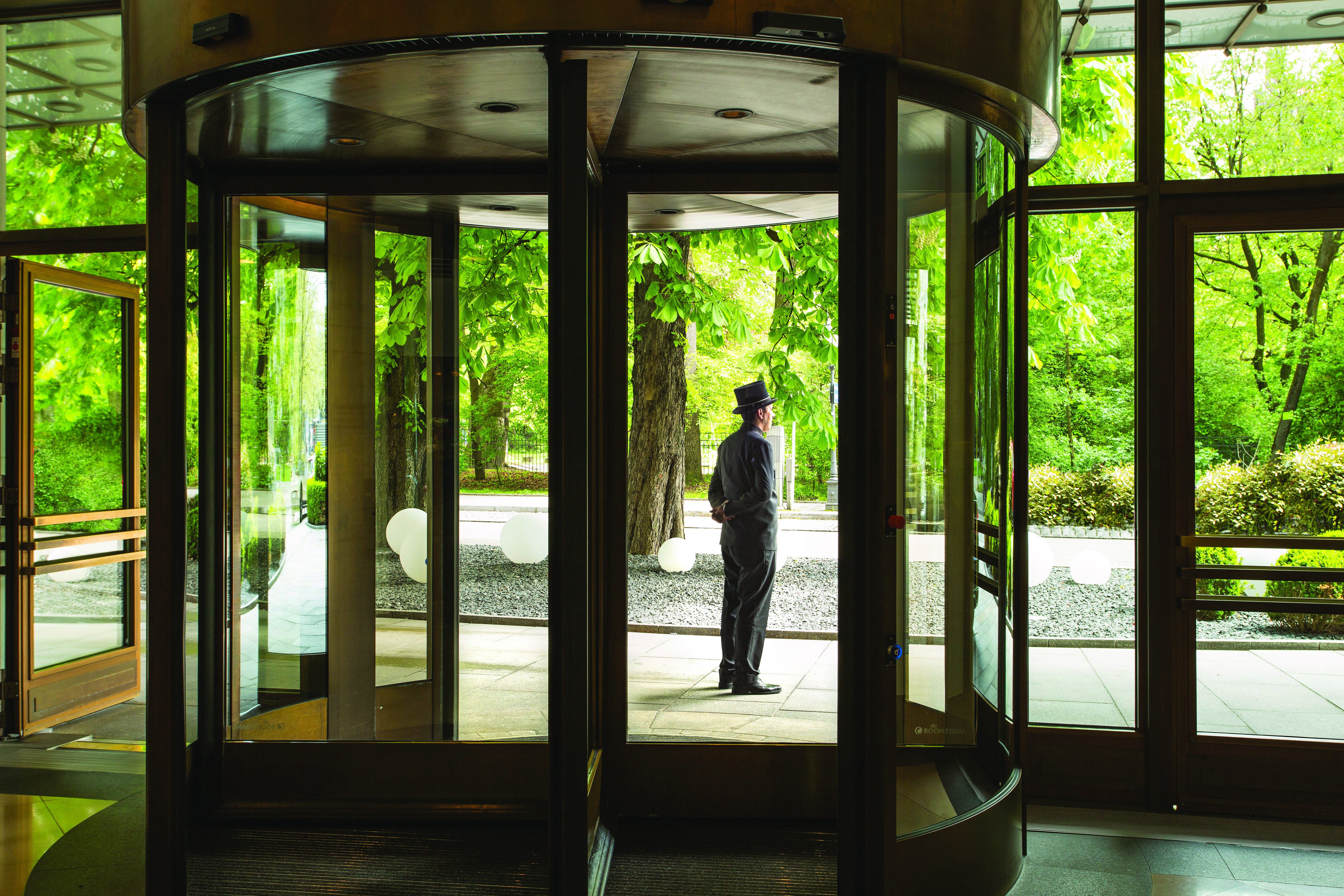 Revolving entrance doors to the hotel with butler standing outside to greet guests
