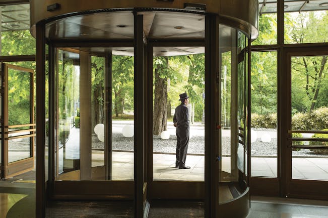 Revolving entrance doors to the hotel with butler standing outside to greet guests