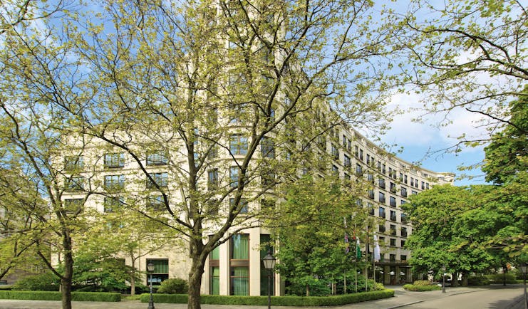 The Charles Hotel Munich exterior large building behind trees