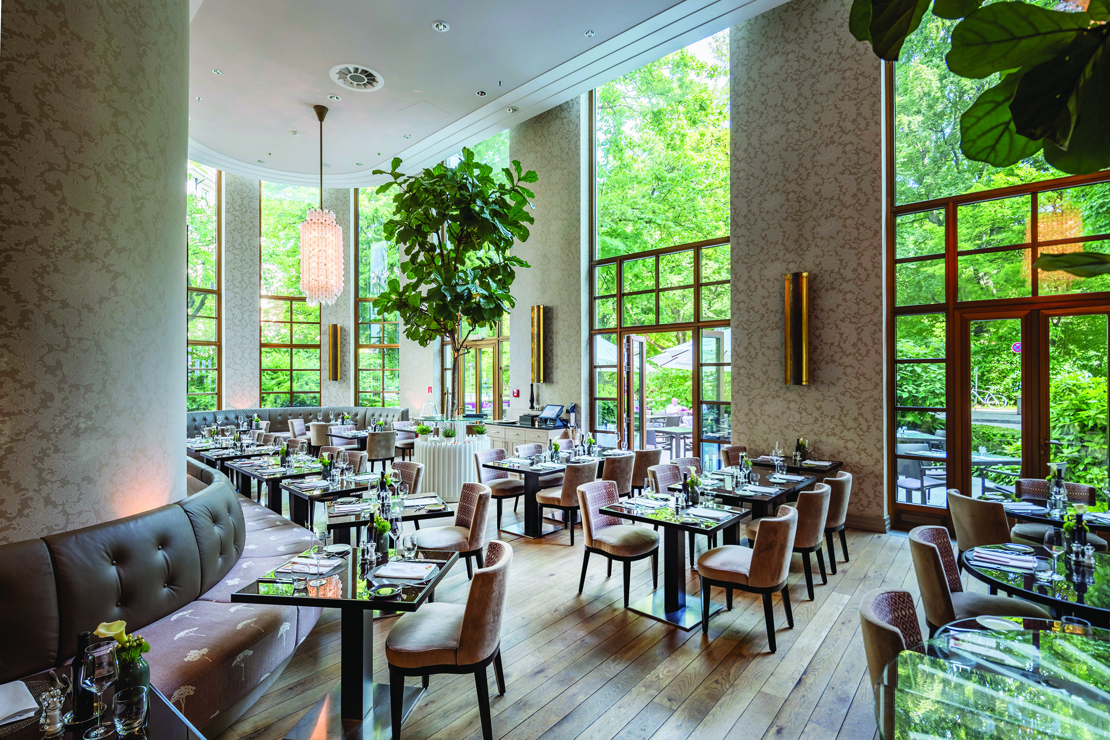 Restaurant dining area at Sophias Restaurant in The Charles Hotel with high window pannelled walls and leather dining chairs set up 