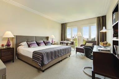 Superior deluxe room at the charles hotel with large bed, doors opening onto a balcony and a flat screen television