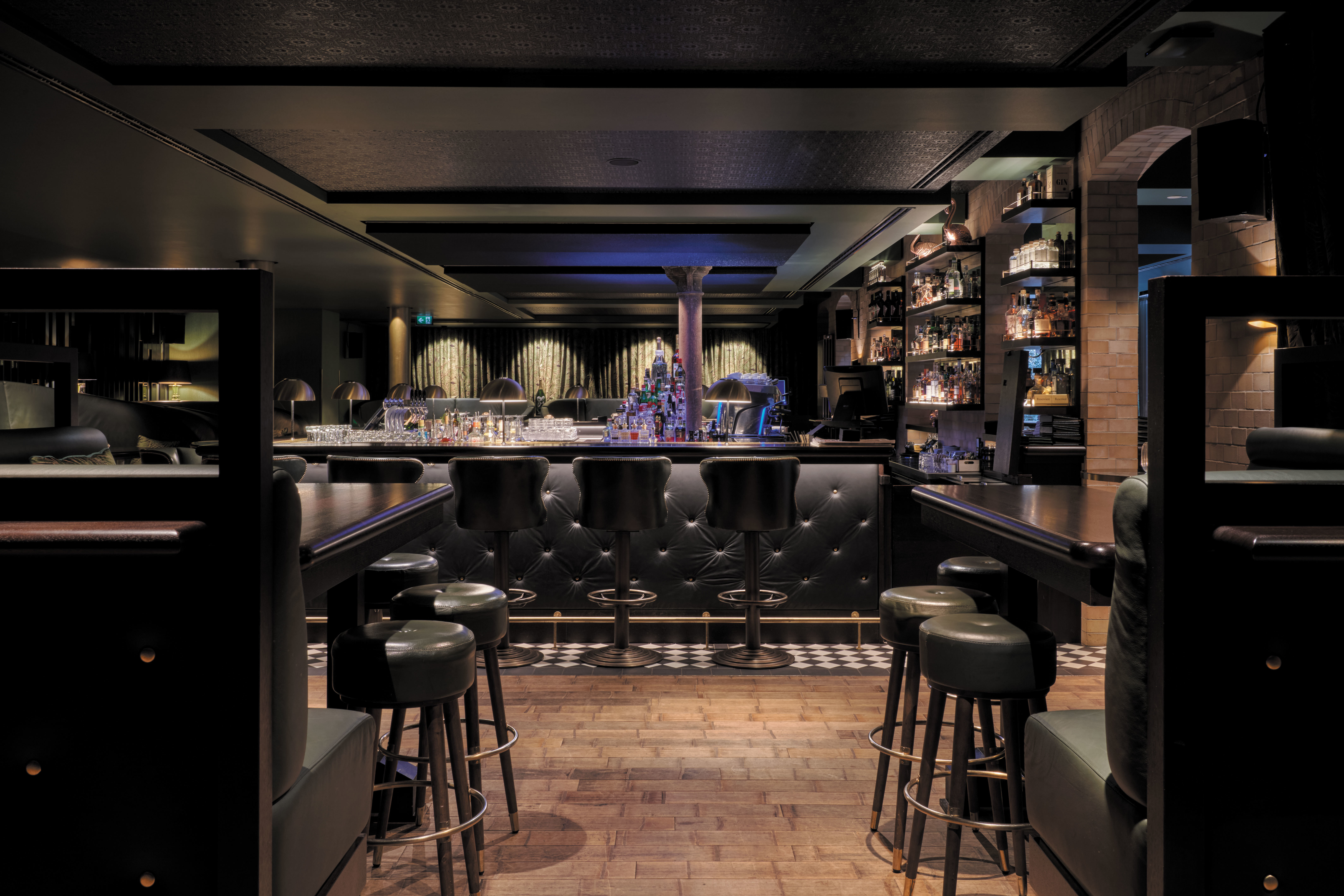 Tortue Hamburg bar noir, black leather bar stools, black woodwork, dark lighting