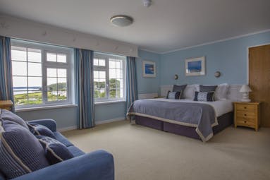St Michael's Resort spacious bedroom with blue walls and views of the sea