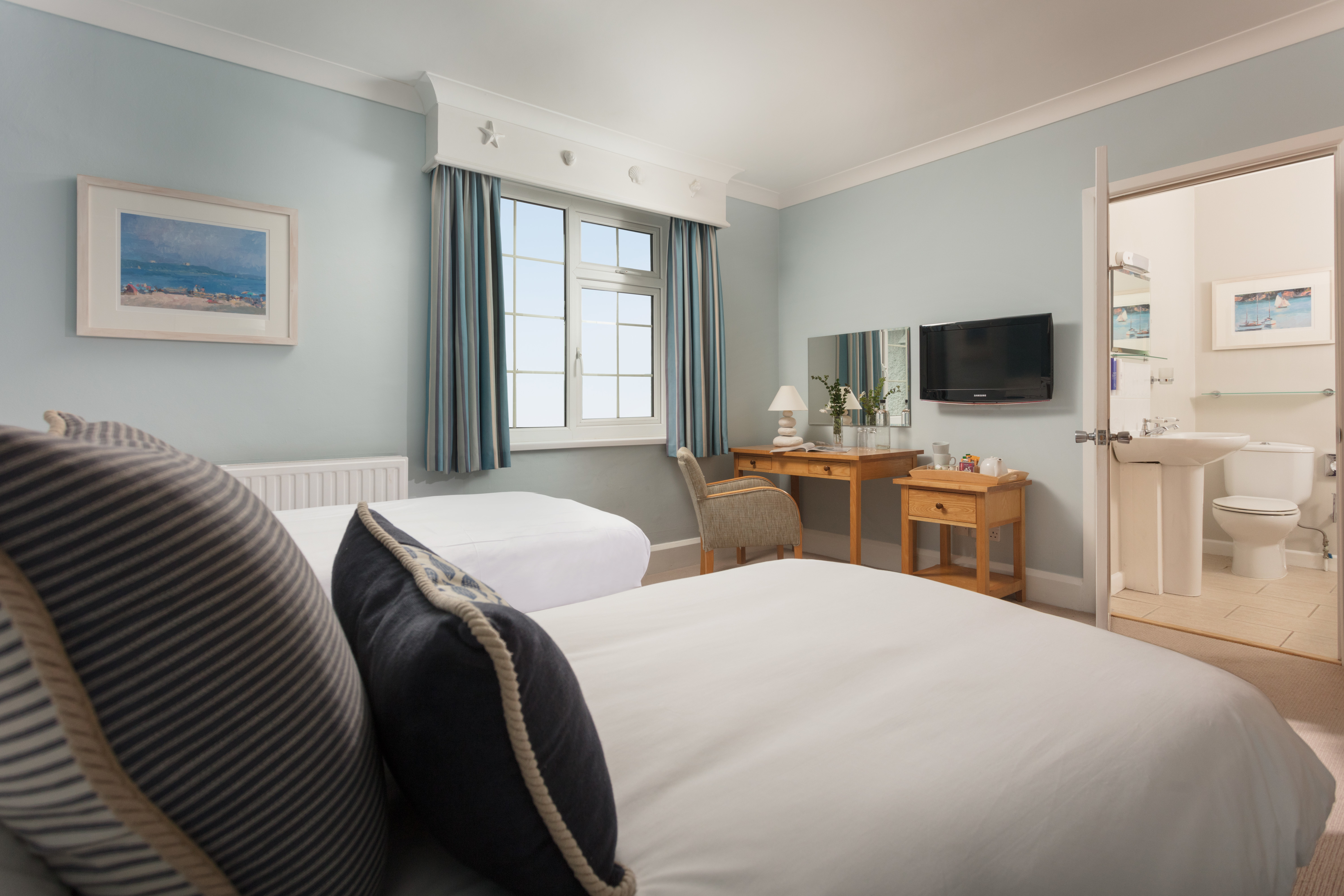 St Michael's Resort bedroom with white covers and blue walls