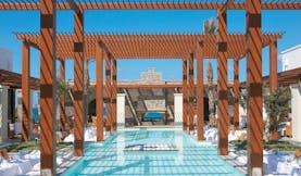Amirandes Greece outdoor pool and pergola outdoor seating area