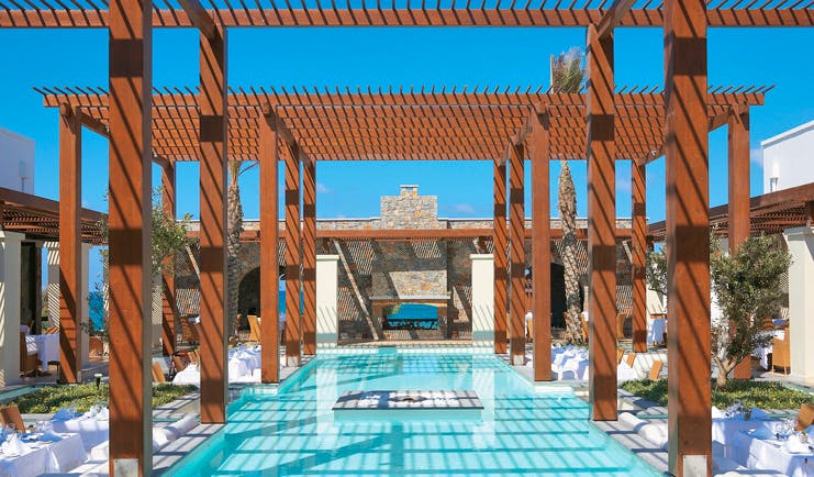 Amirandes Greece outdoor pool and pergola outdoor seating area