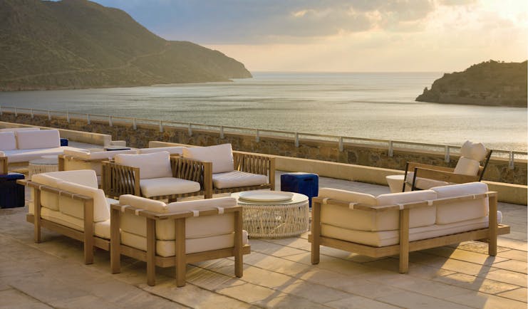 Blue Palace Greece terrace area with armchairs and sea view