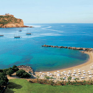 Cape Sounio Greece beach ocean sun loungers umbrellas boats on the waves