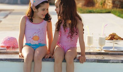 Cape Sounio Greece children sitting next to a swimming pool