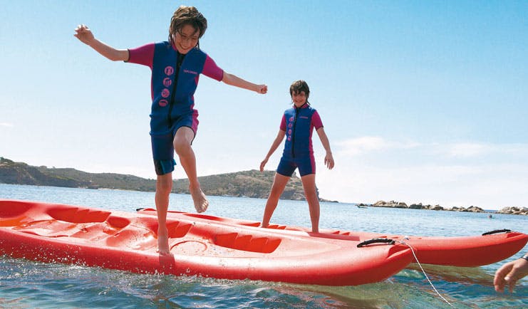 Cape Sounio Greece kids club group of children in wetsuits and snorkels