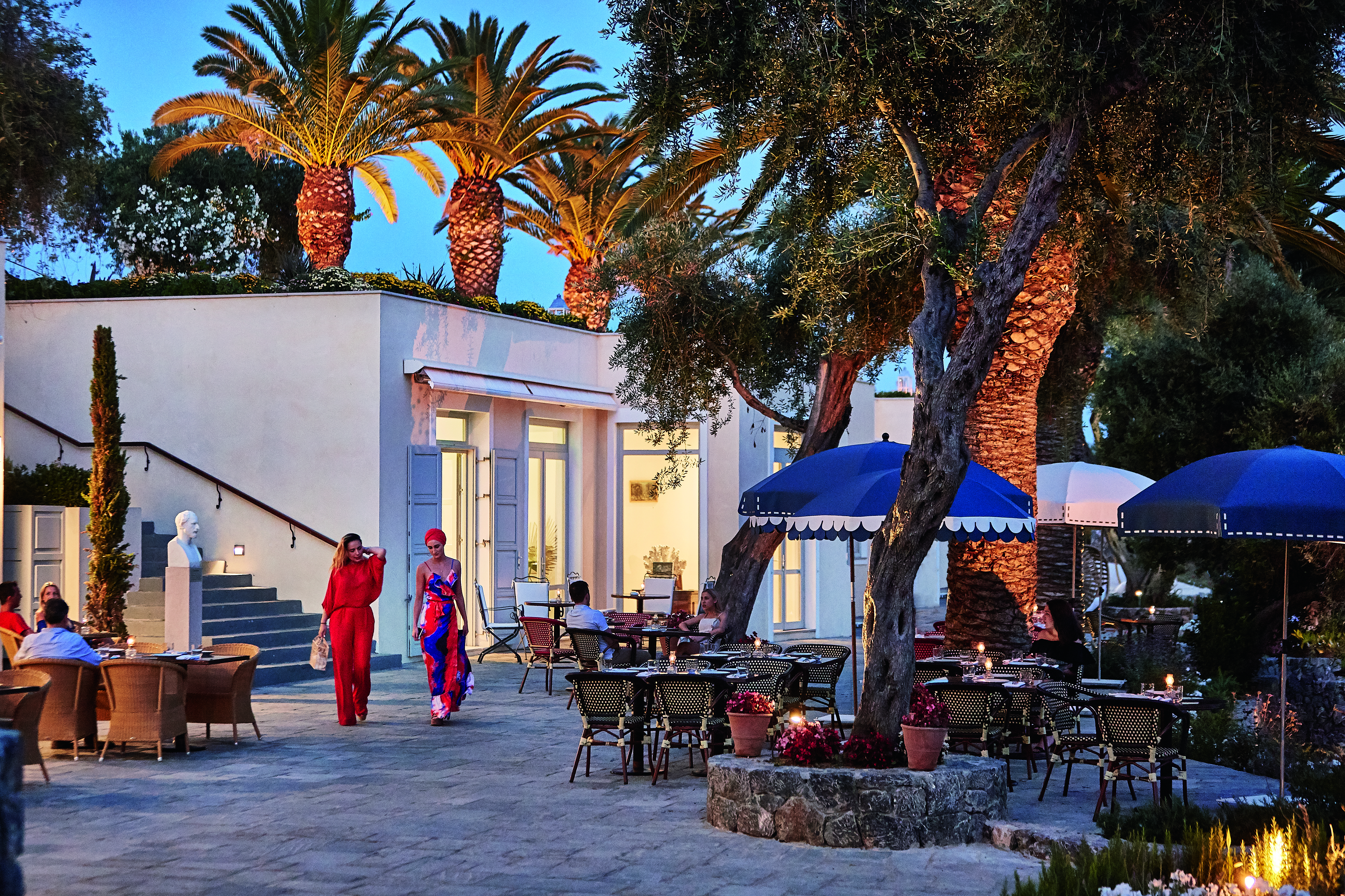 Courtyard dining at night with palm trees Corfu Imperial