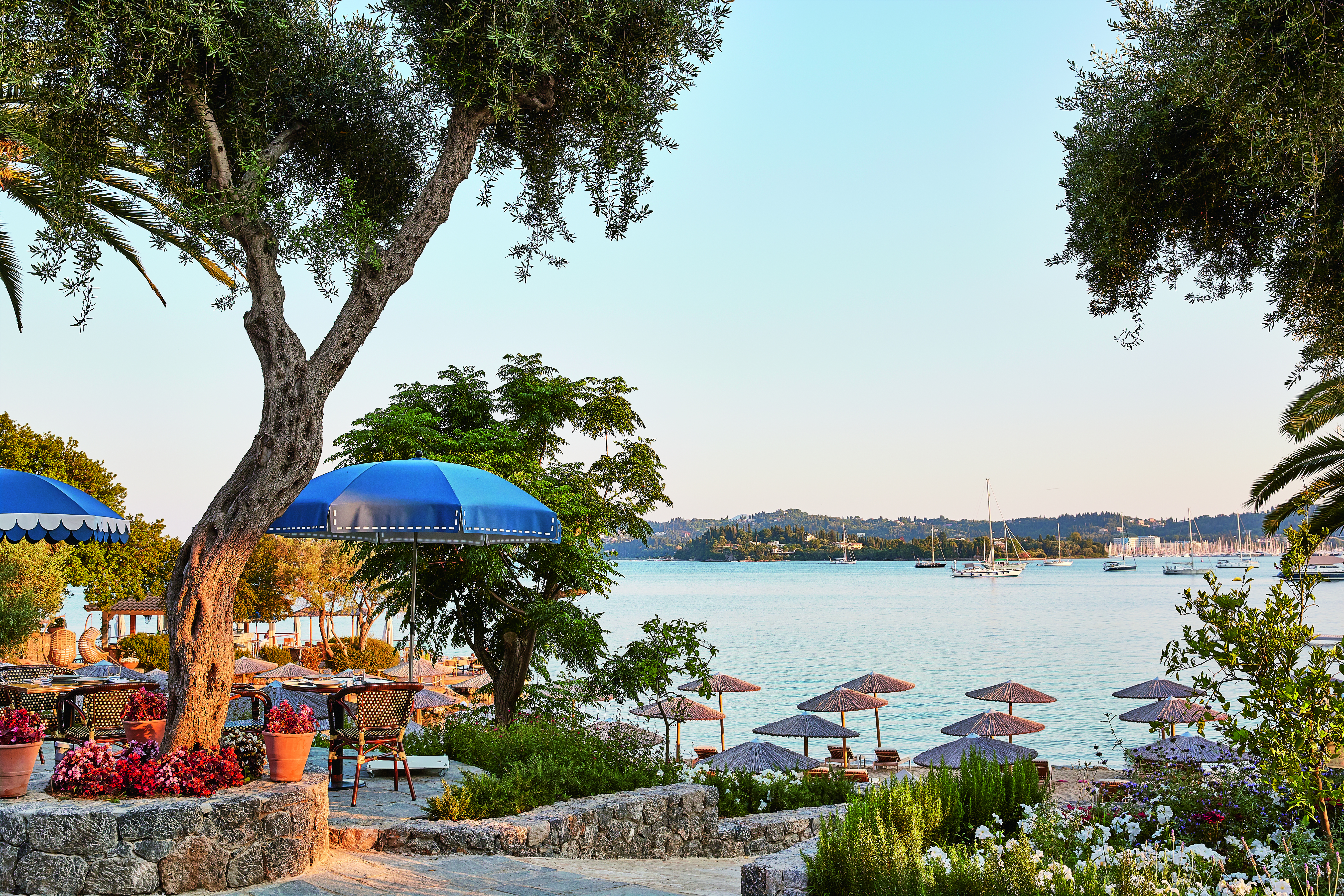 Blue umbrellas on terrace overlooking sea