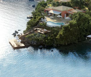 Villa on rocky promontory with pool and beach platform