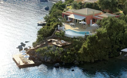 Villa on rocky promontory with pool and beach platform