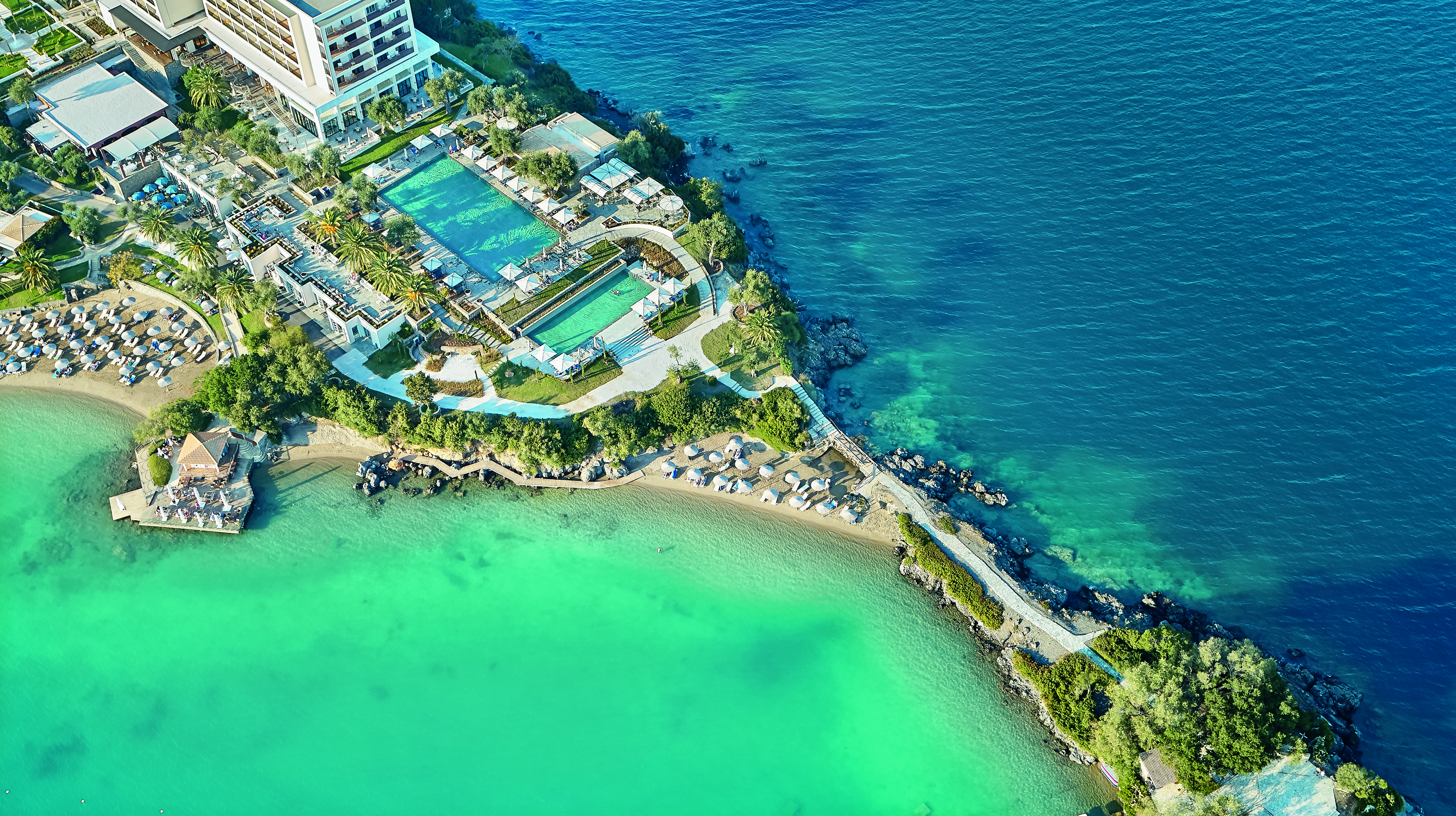 Aerial view of blue pools and sea at Corfu Imperial