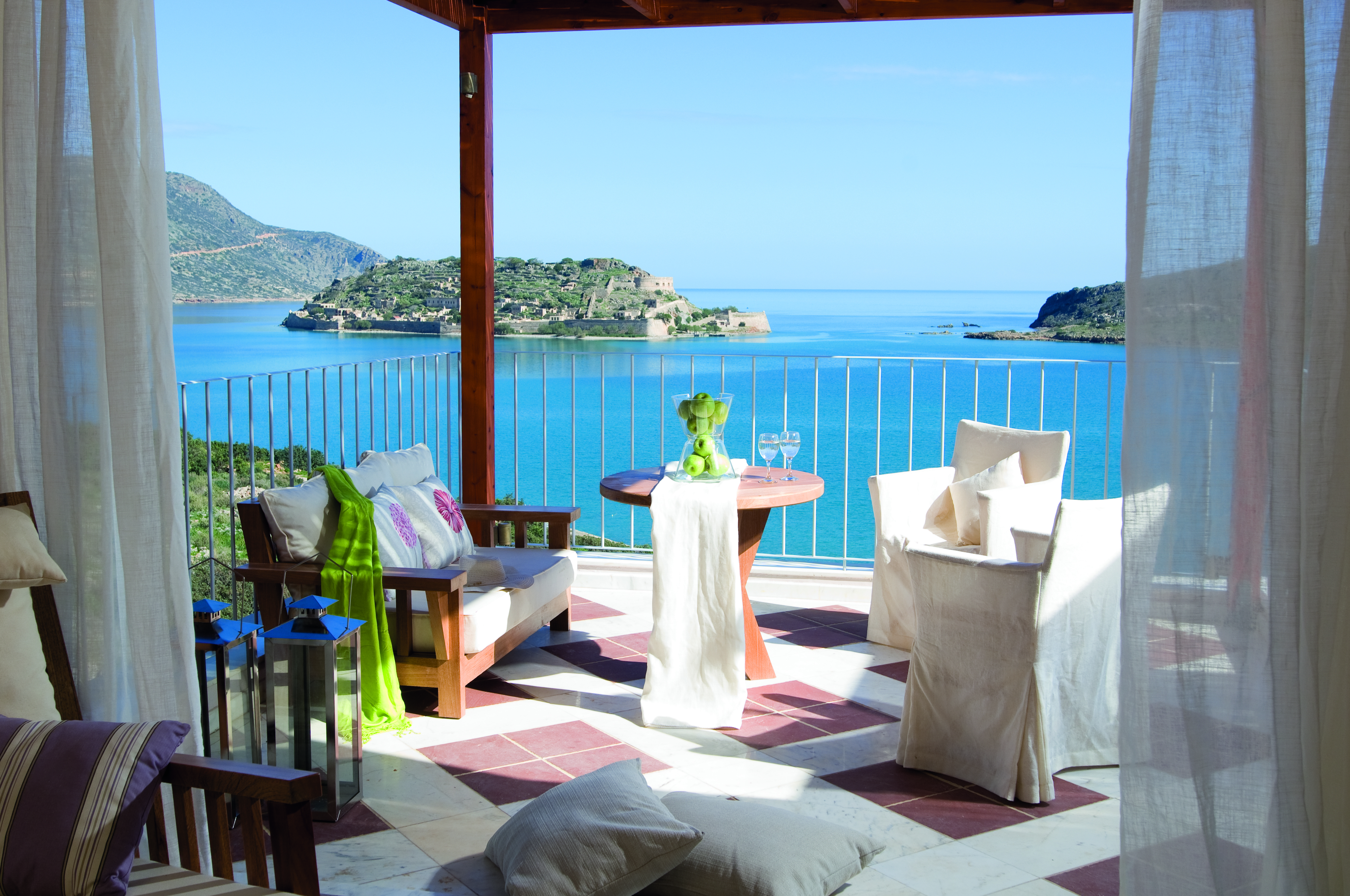Domes of Elounda Greece balcony with sofa and chairs and sea view