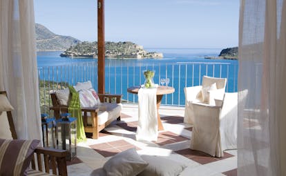 Domes of Elounda Greece balcony with sofa and chairs and sea view