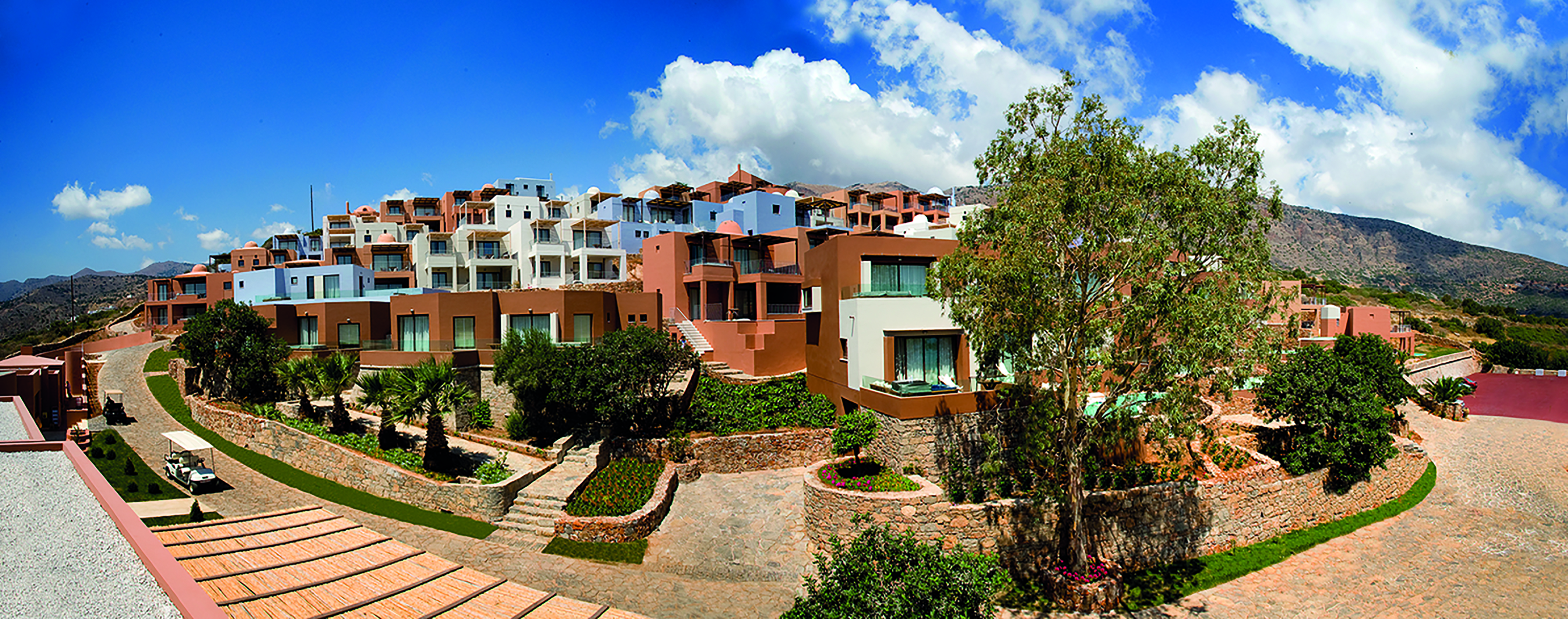 Domes of Elounda Greece exterior several terracotta white and blue buildings