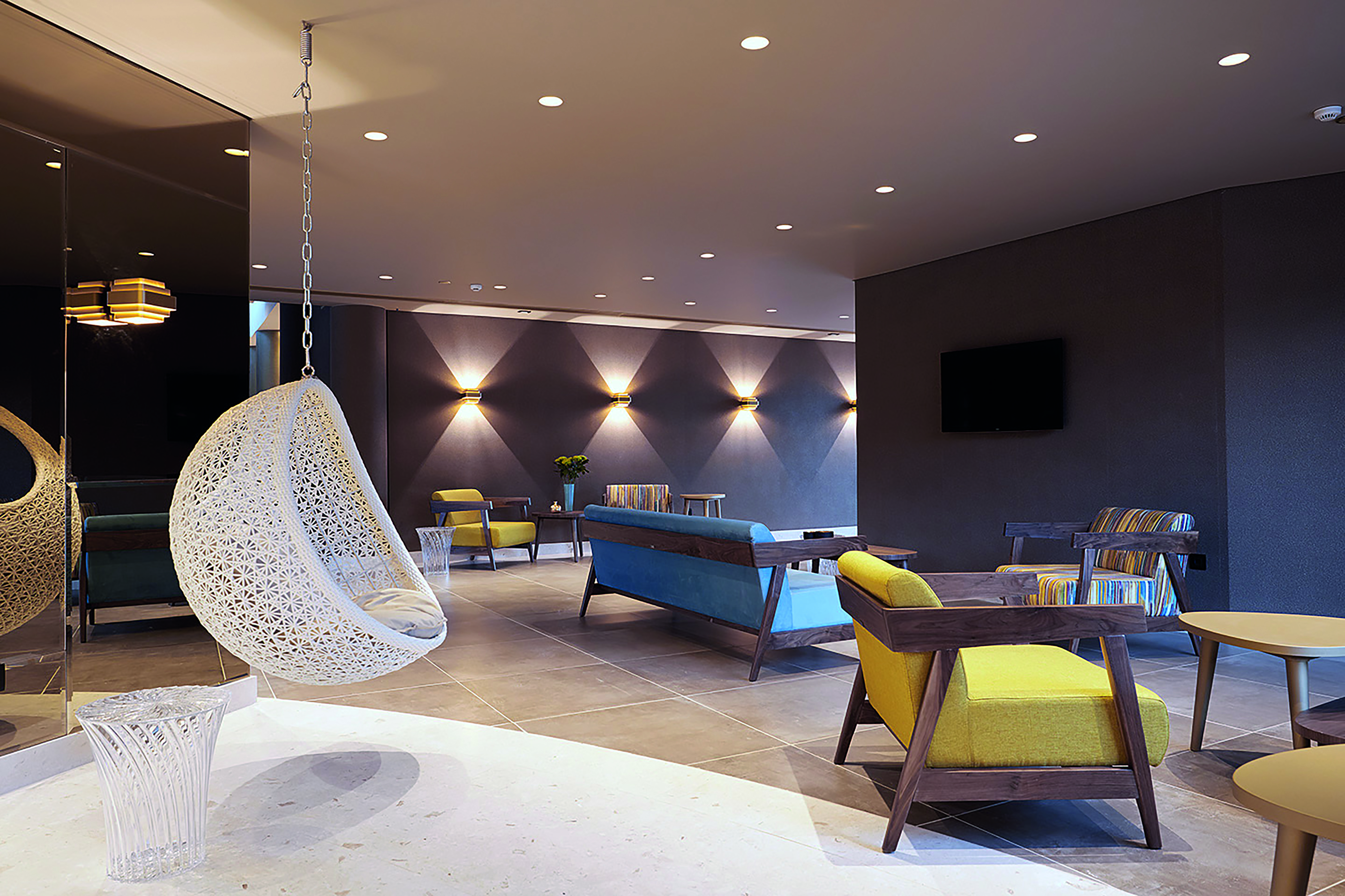 Domes of Elounda Greece lounge area with sofas and a hanging chair