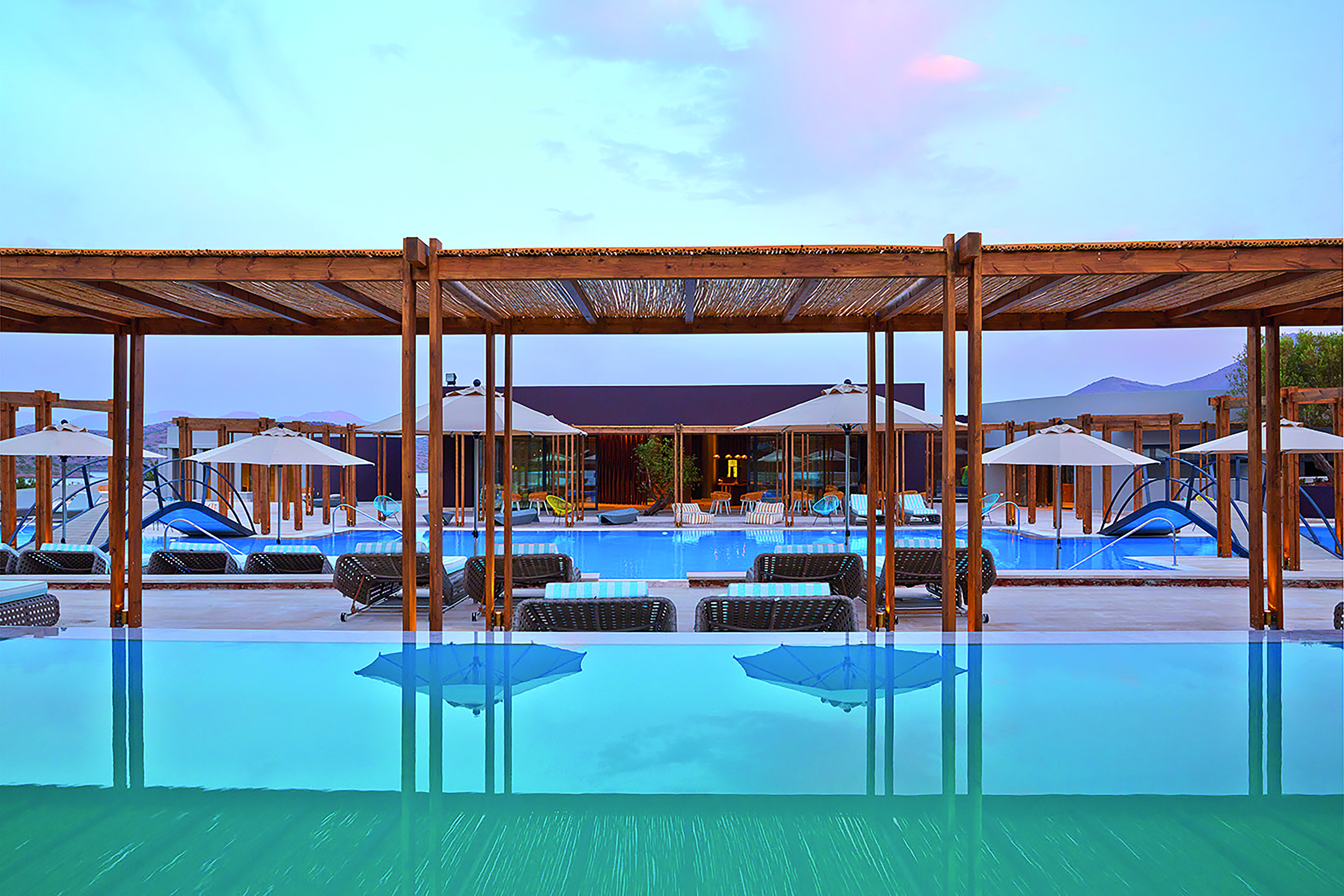 Domes of Elounda Greece outdoor pool with umbrellas