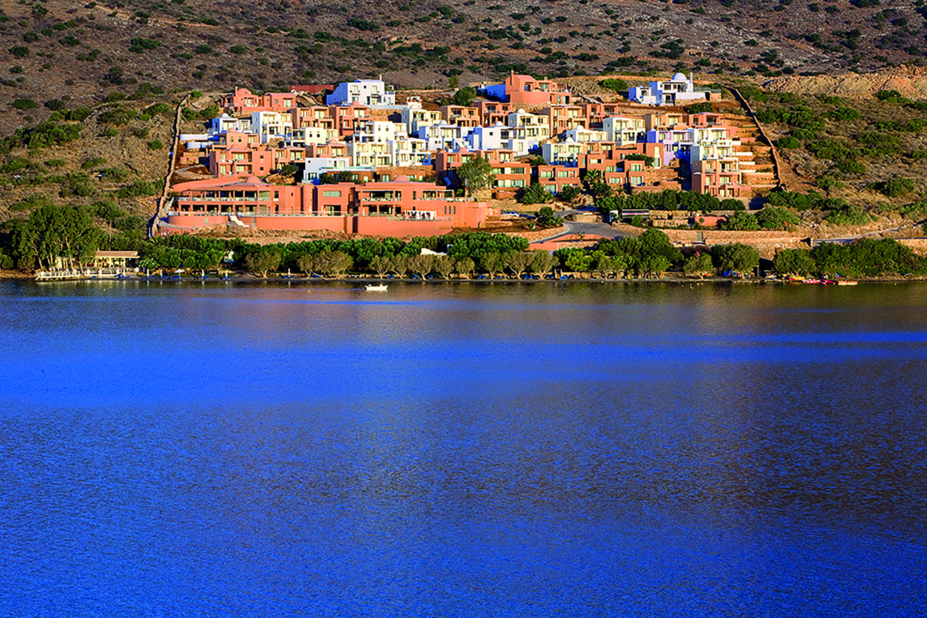 Domes of Elounda Greece panorama view of terracotta buildings from the sea