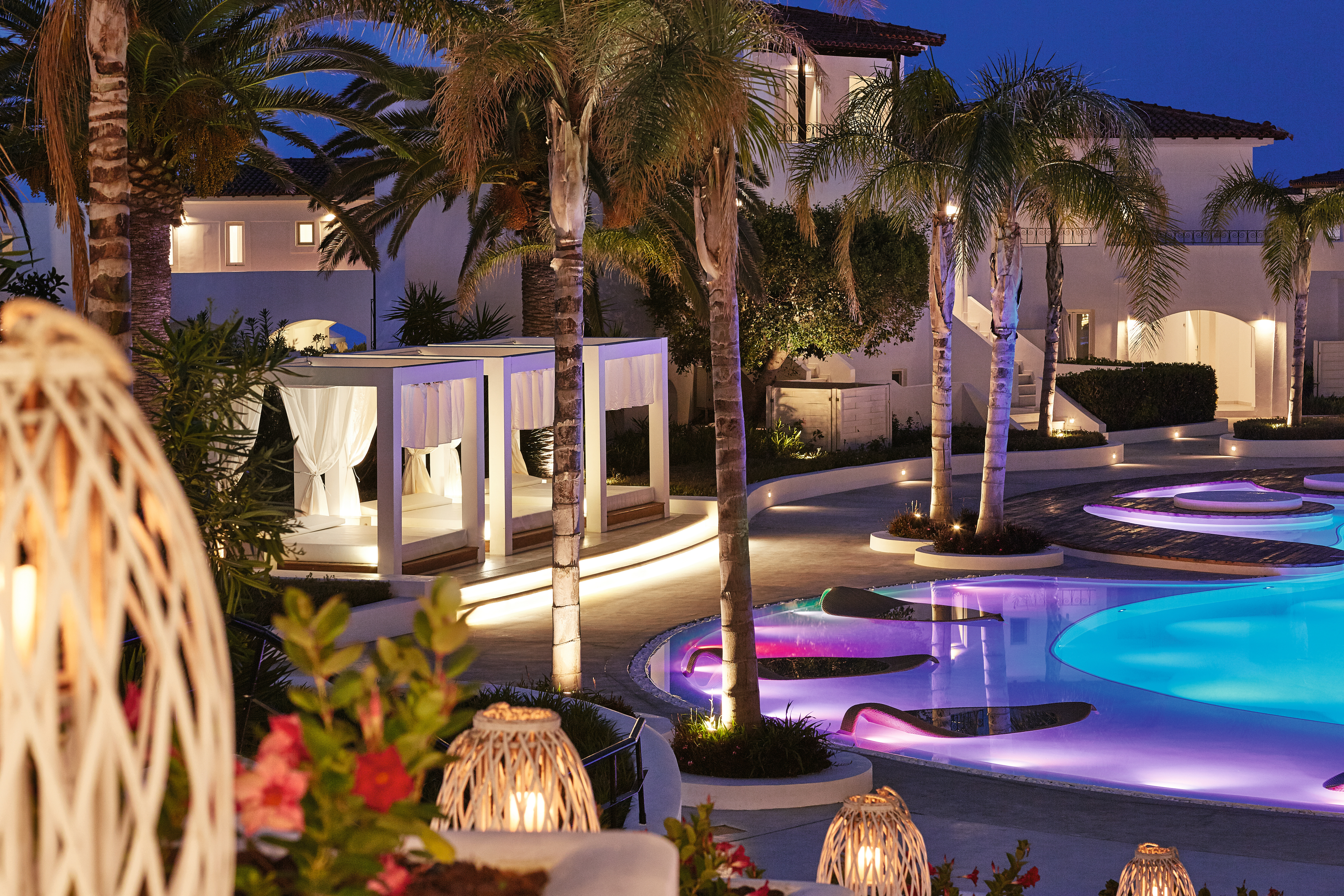 Grecotel Caramel Greece outdoor pool night with coloured lights in the water