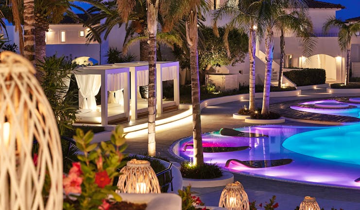 Grecotel Caramel Greece outdoor pool night with coloured lights in the water