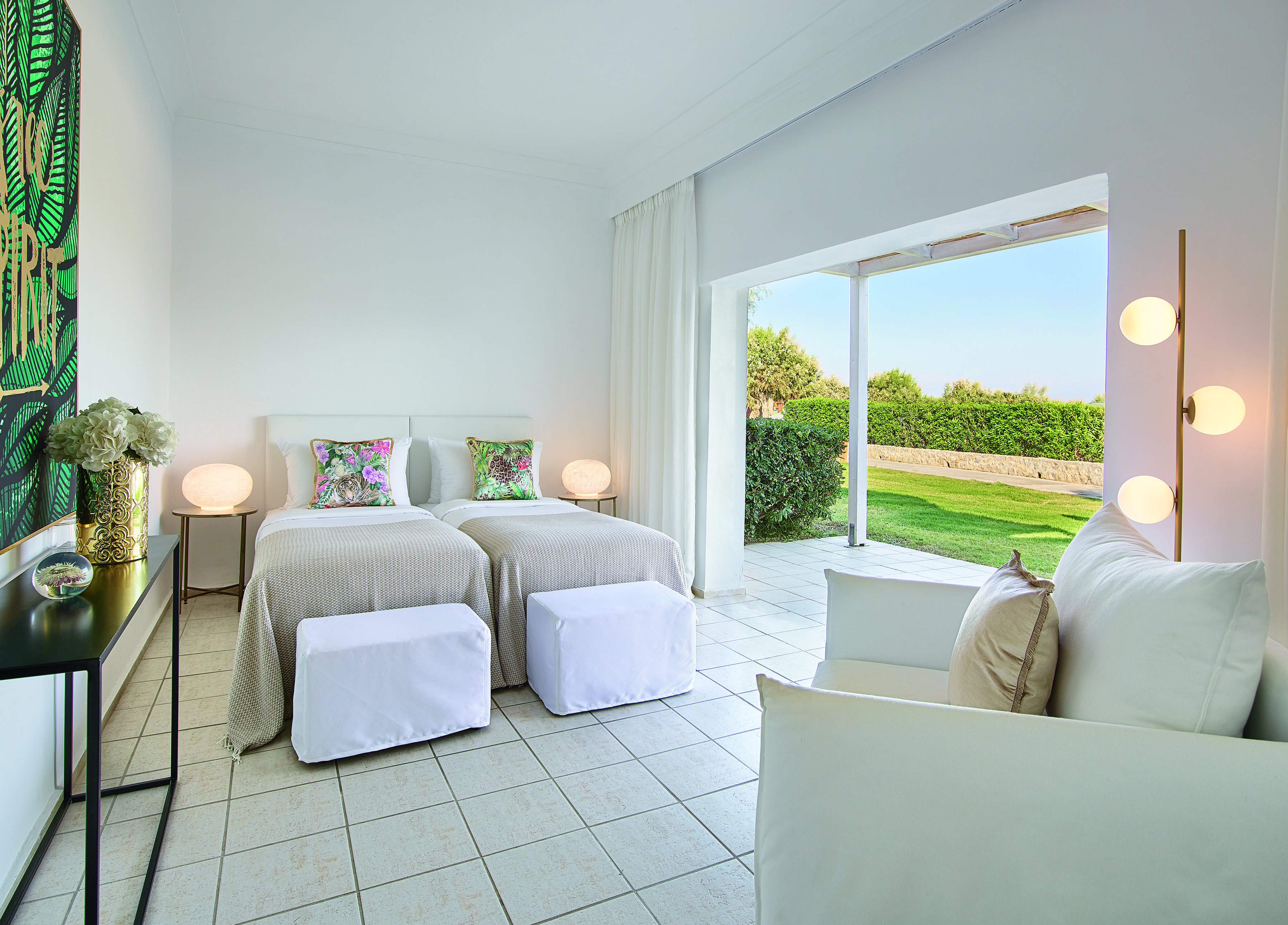 Twin room with tiled floor and large open window to garden