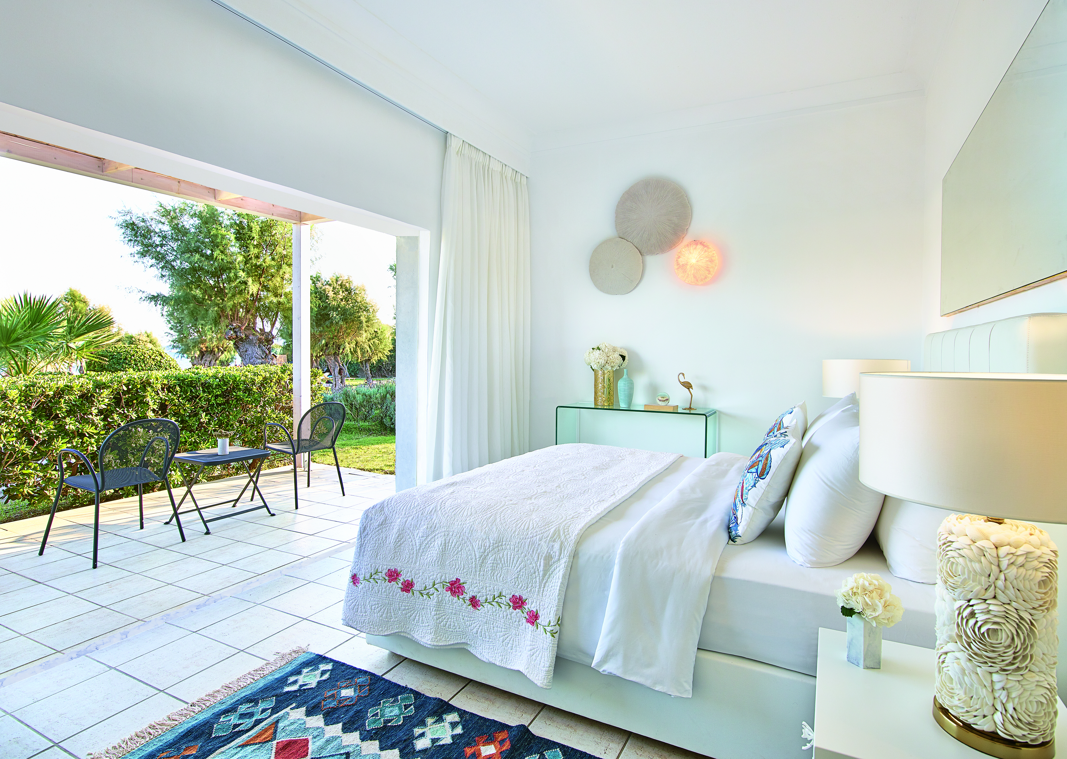 White room tile floor opening onto garden terrace