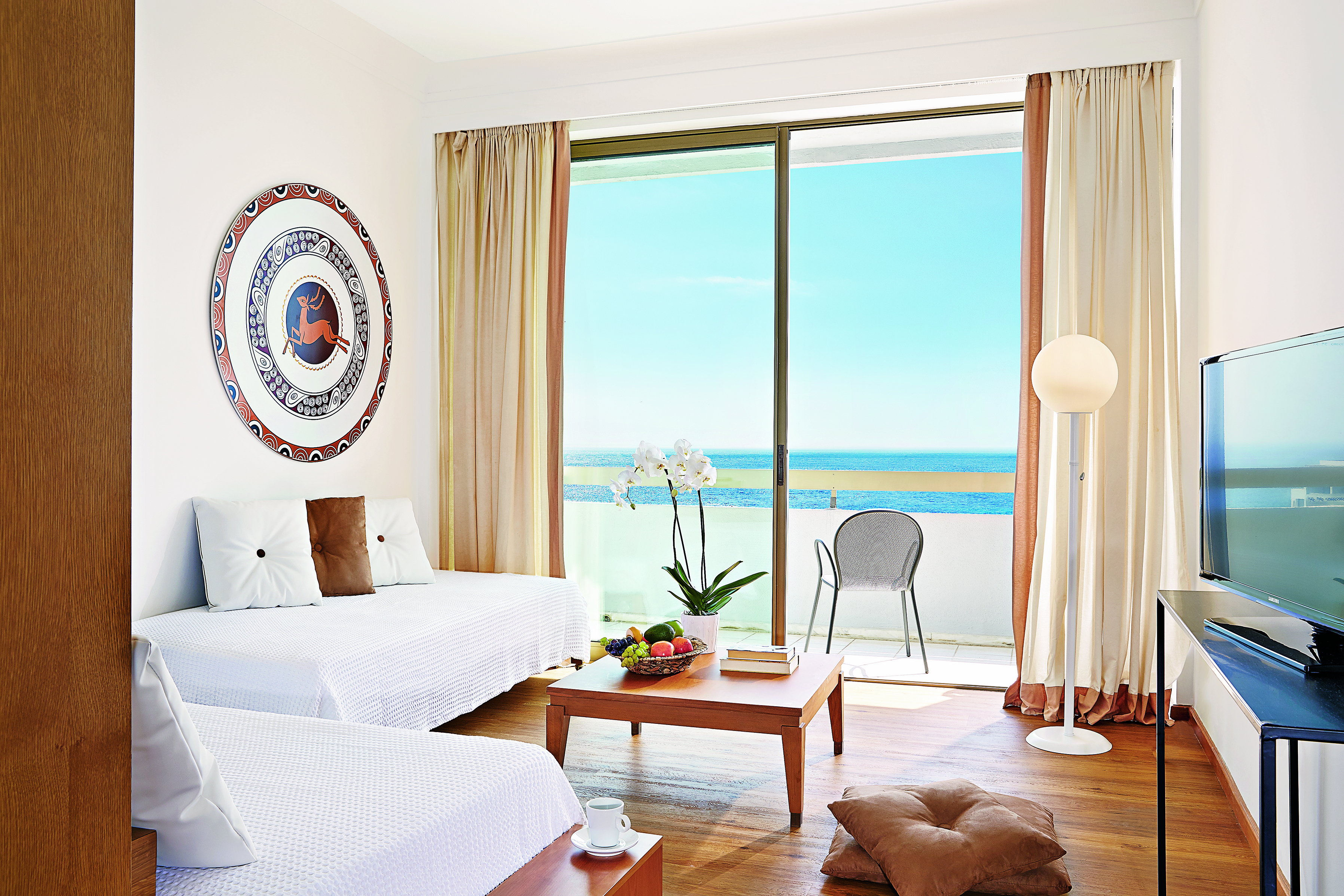 White room with blue of sky and sea outside