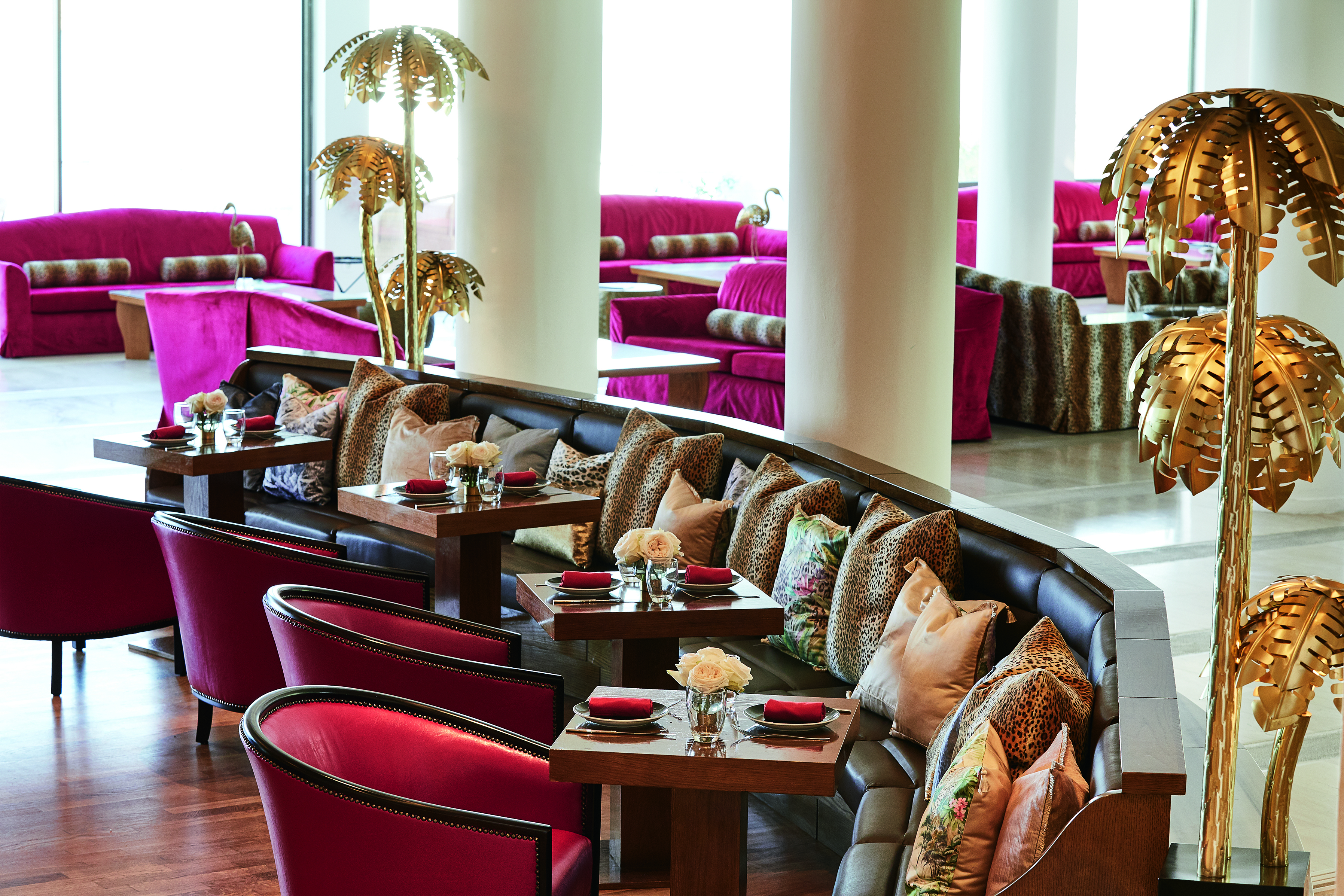 Red curved seating with bar tables