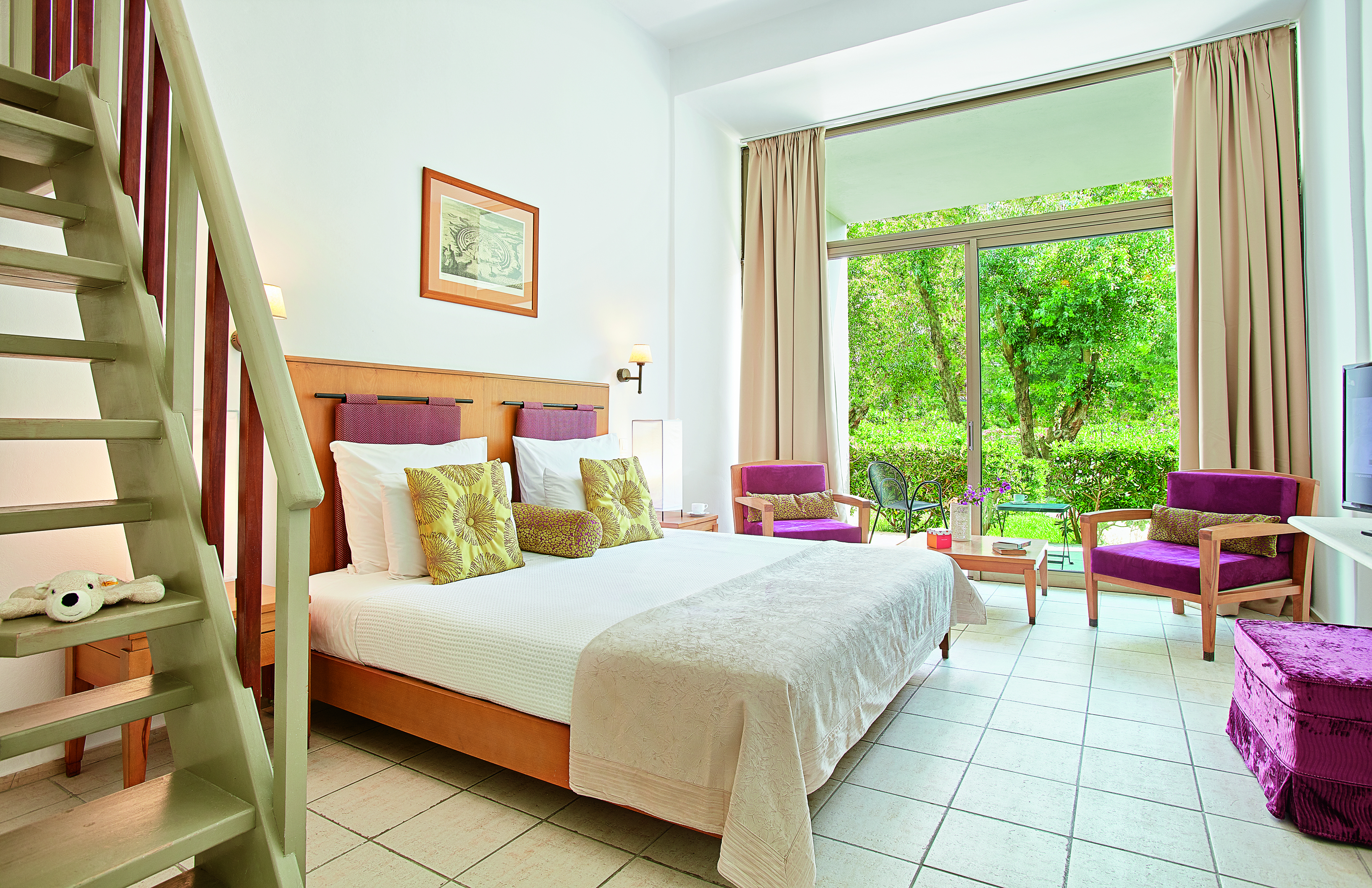 room with garden outside and steps to second floor