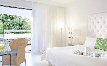 Grecotel White Palace whte room with rattan chair