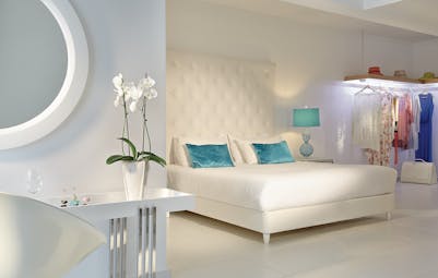 Grecotel White Palace white suite with flowers and green cushions