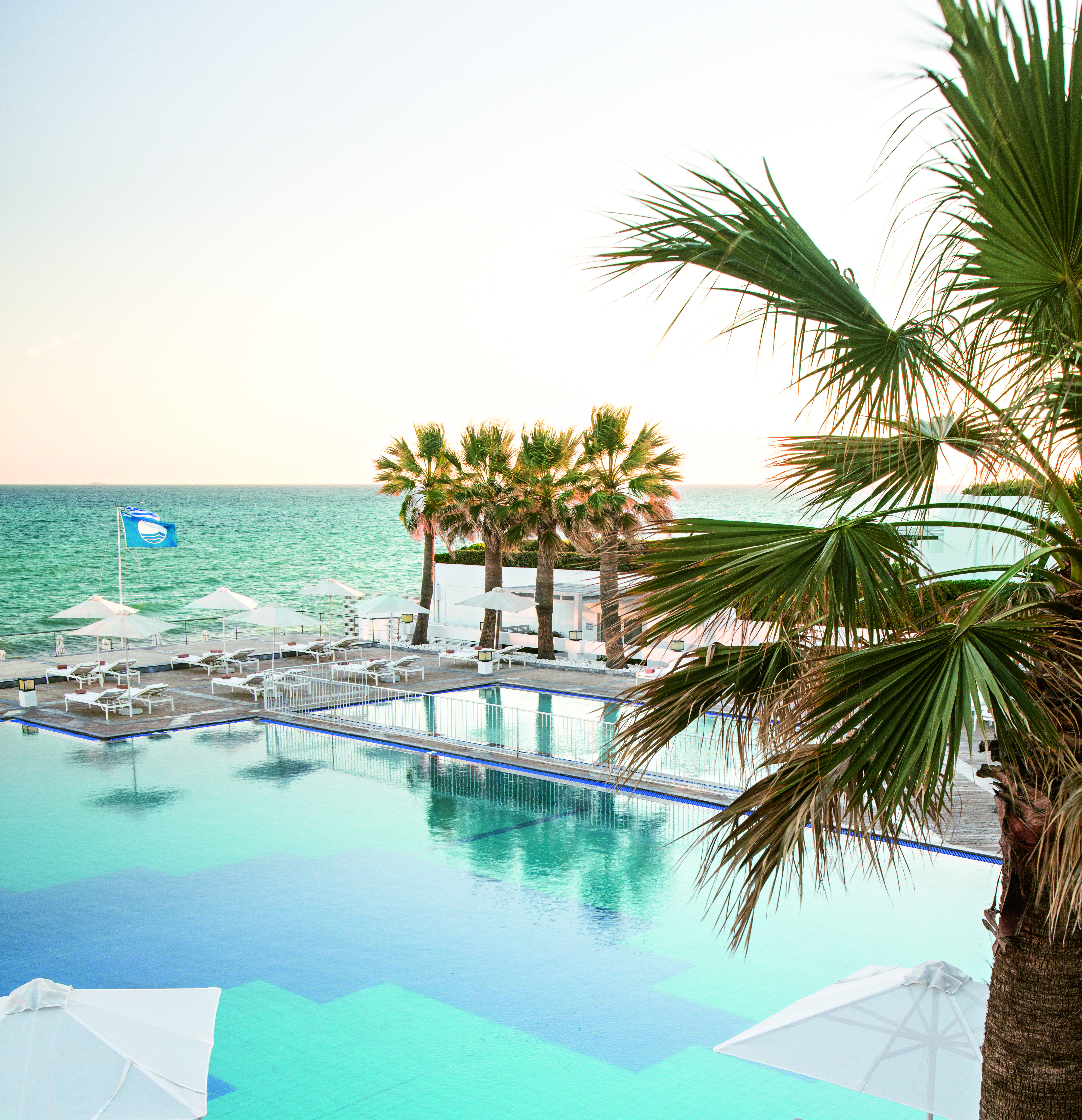 Grecotel White Palace blue pool and flag