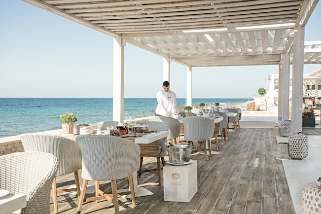 Grecotel White Palace seaside restaurant decking white chairs