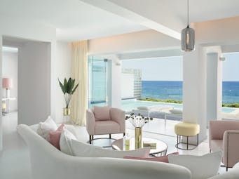 Grecotel White Palace suite opening onto pool with sea view