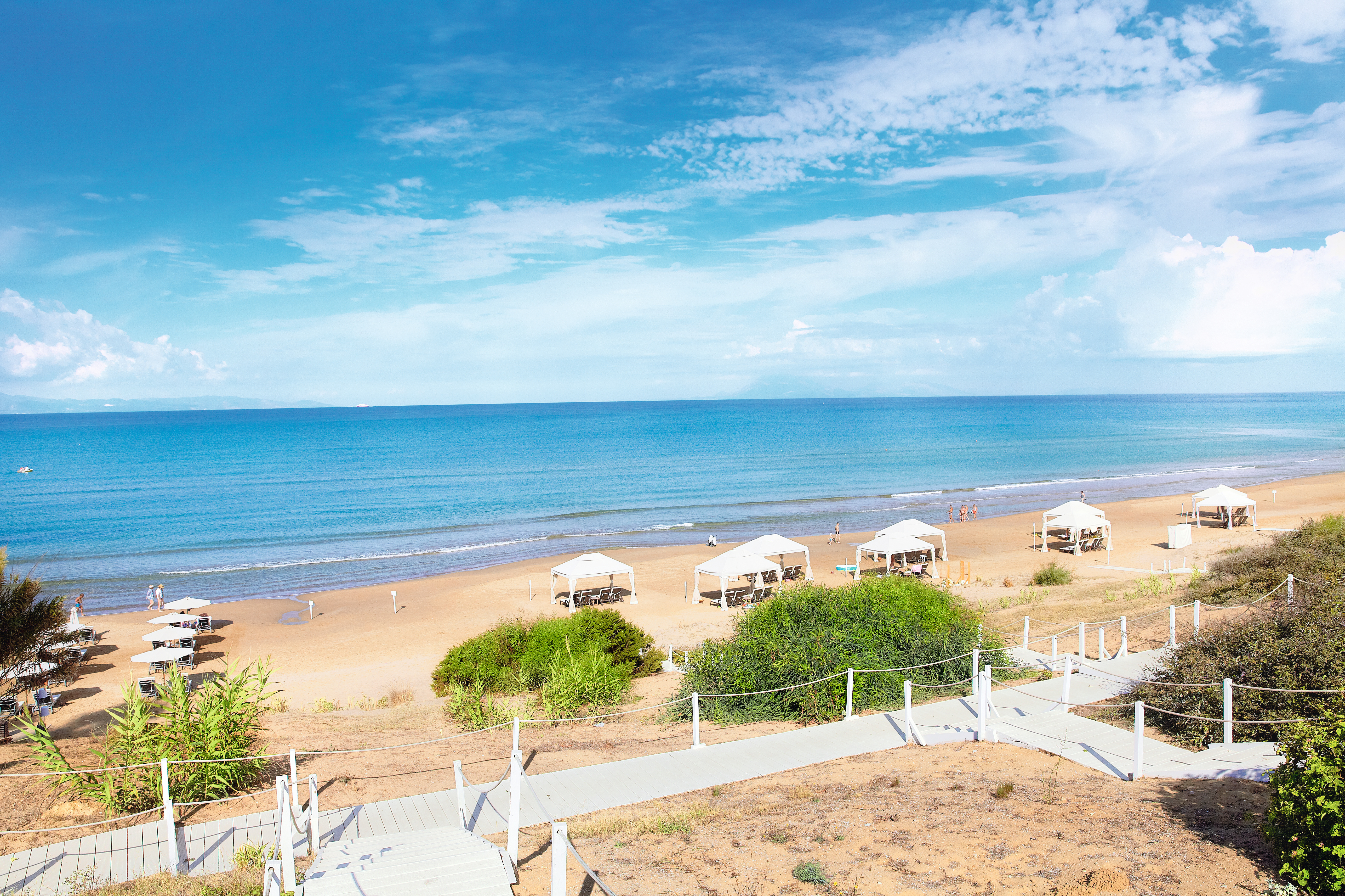 Grecotel Mandola Rosa Greece beach with white pergolas